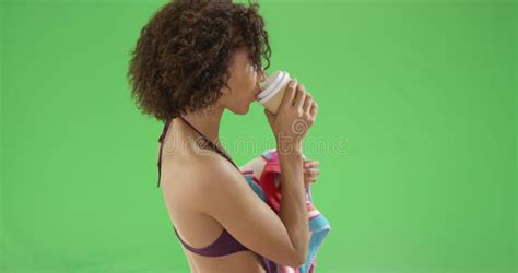 Young Millennial African American Woman Drinks Coffee On Green Screen