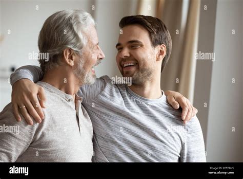 Smiling Mature Father And Adult Son Hugging Stock Photo Alamy