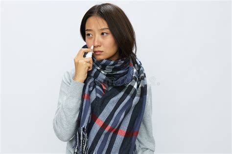 Asian Woman Flu Cold with Stuffy Nose Holds Nasal Spray and Sprays ...