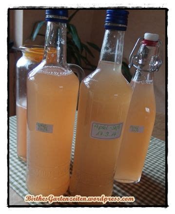 Three Bottles Filled With Liquid Sitting On Top Of A Table