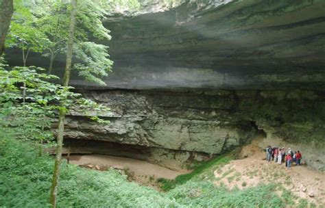 Some People Are Standing In The Middle Of A Cave