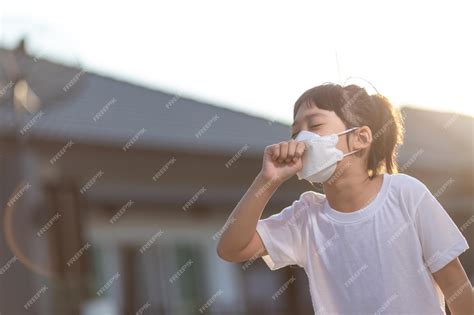 Premium Photo | Asian child girl wearing mask sick with sneezing on the ...