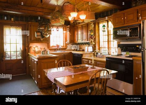 Square dining table and rounded high back chairs in rustic kitchen ...