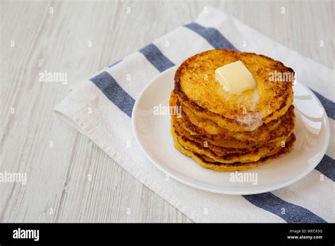 Homemade Corn Meal Johnny Cakes With Butter On A White Plate Side View