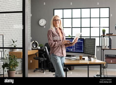 Mature Female Programmer Working With Laptop In Office Stock Photo Alamy