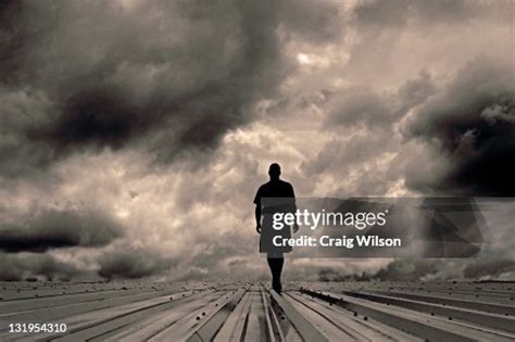 Man Walking Towards Storm High Res Stock Photo Getty Images