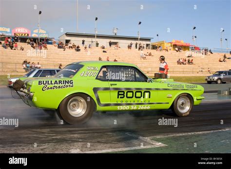 Ford Mustang drag racing car performing a burnout Stock Photo - Alamy