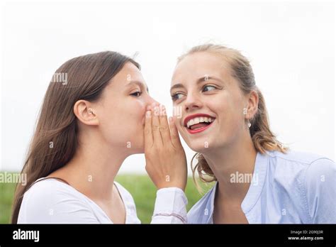 Blond Woman Looking Away While Listening To Female Friend Gossiping