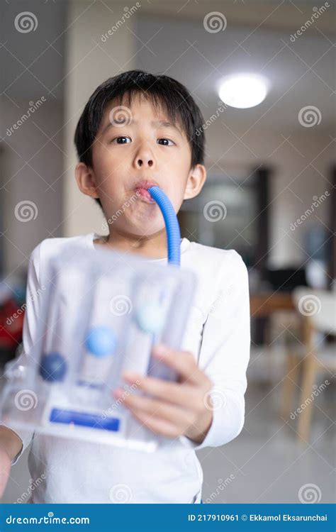 Thin Boy Uses A Tri Ball Incentive Spirometer For Check His Lung