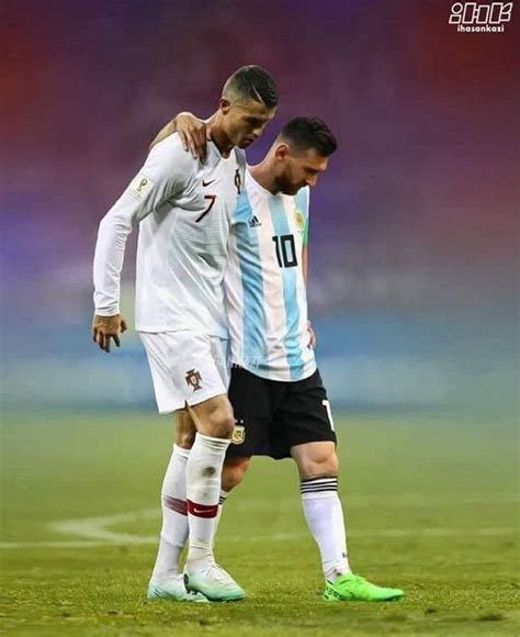 Two Soccer Players Standing Next To Each Other On A Field With Their