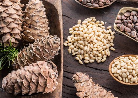 pine nuts   spoon  pine nut cone   wooden table organic