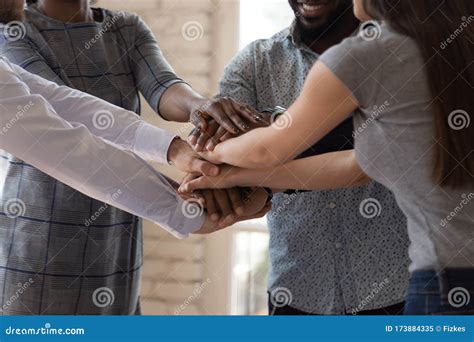 Diverse Businesspeople Stacking Hands Together Engaged in Team Building ... 