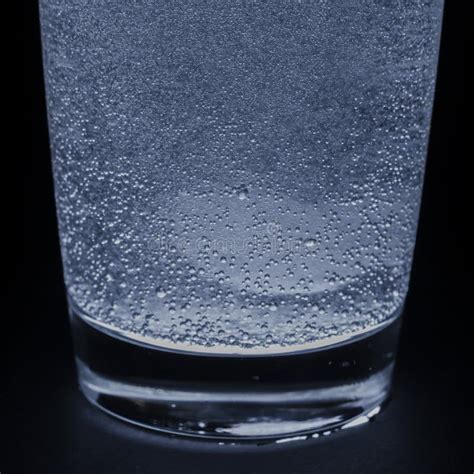 A Soluble Tablet Dropped In A Glass Of Water Over Dark Background Stock