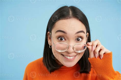 Portrait Of Brunette Japanese Woman In Glasses Smiling And Looking
