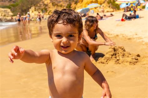 Premium Photo Playing In The Sand On The Beach At Praia Do Barranco