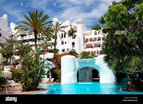 Swimming pool with waterfall and building of luxury hotel, Tenerife island, Spain Stock Photo ...