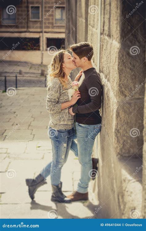 Candid Portrait Of Beautiful European Couple With Rose In Love Kissing