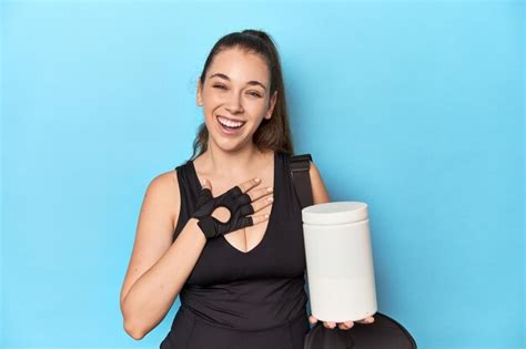 Premium Photo Young Woman Holding Protein Bottle In Sporty Setting