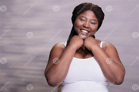 African American Body Positive Woman Holding Hands Under Chin Stock