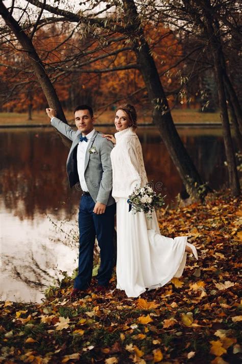 Beloved Couple Standing Ar Lake Pear Embracing And Kissing Stock