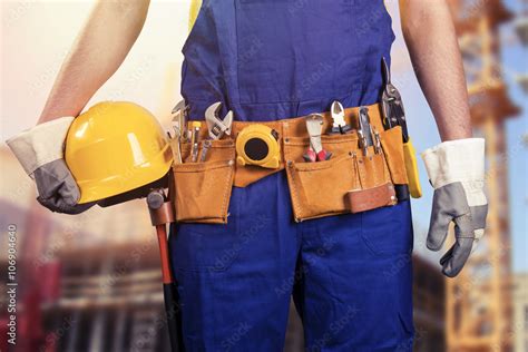 construction worker with tools belt at building site Stock Photo ...