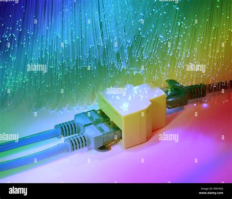 Network Cables And Hub Closeup With Fiber Optical Background Stock