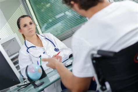 Doctor Comforting Disabled Patient Stock Image Image Of Scrubs Multiracial 99325413