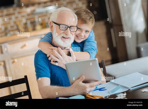 Happy Cute Boy Hugging His Grandfather Stock Photo Alamy