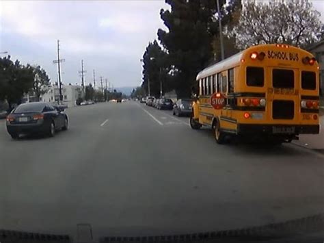 Driver Passing School Bus With Flashing Red Lights