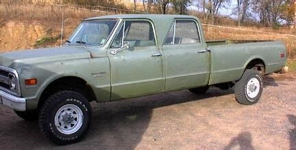 An Old Green Pick Up Truck Parked In A Parking Lot