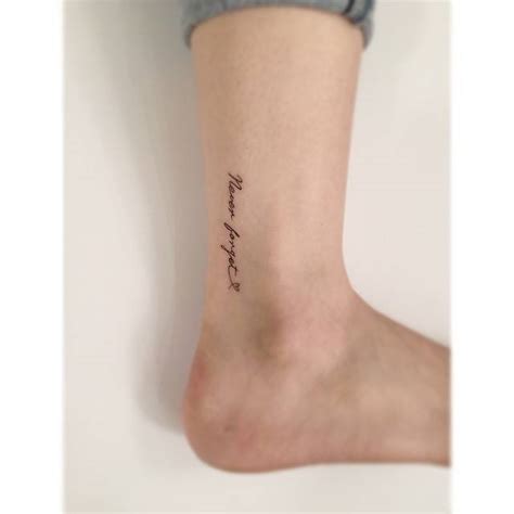 Never Forget Lettering Tattoo Located On The Ankle