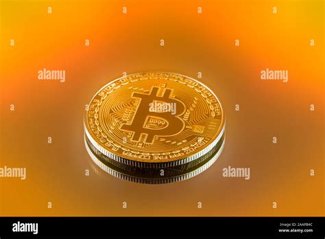 Gold Color Physical Bitcoin Crypto Currency In Bright Light With Yellow