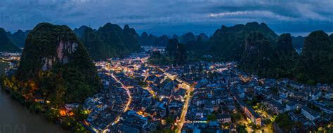 Aerial view of Guilin Mountains surrounding by city during the night ...