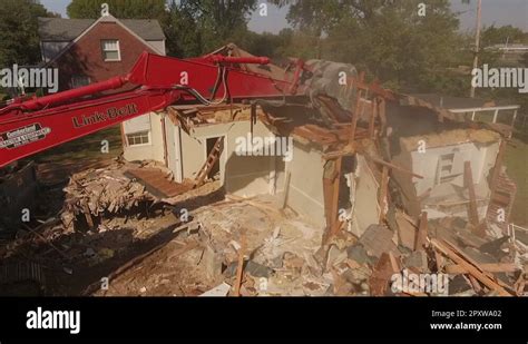 Excavator Biting Through Roof Of Demolished House Stock Video Footage