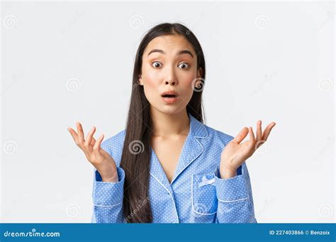 Close Up Of Confused And Shocked Asian Girl In Blue Pajama Stare