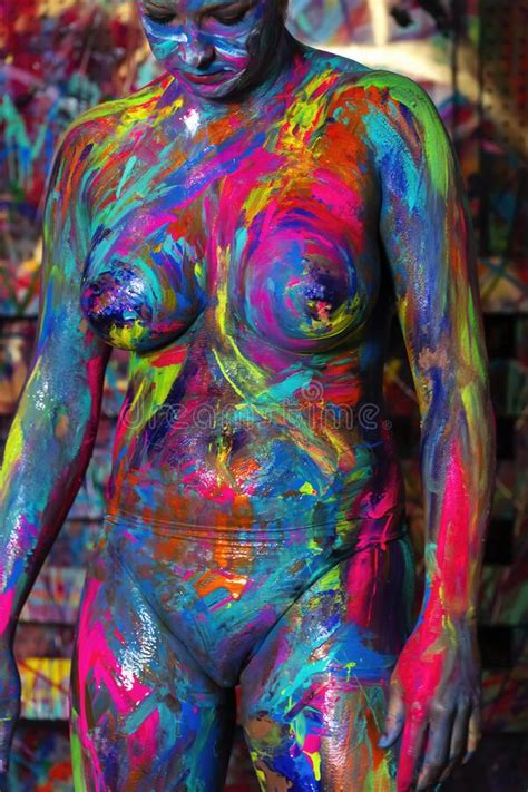 Naked Female Is Being Painted With Colorful Paint In A Home Environment