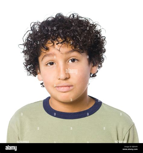 Studio portrait of boy (8-9) with curly hair Stock Photo - Alamy