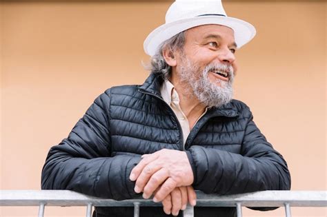 Premium Photo Portrait Of A Confident Handsome Mature Man Pensioner Grandfather Near His House
