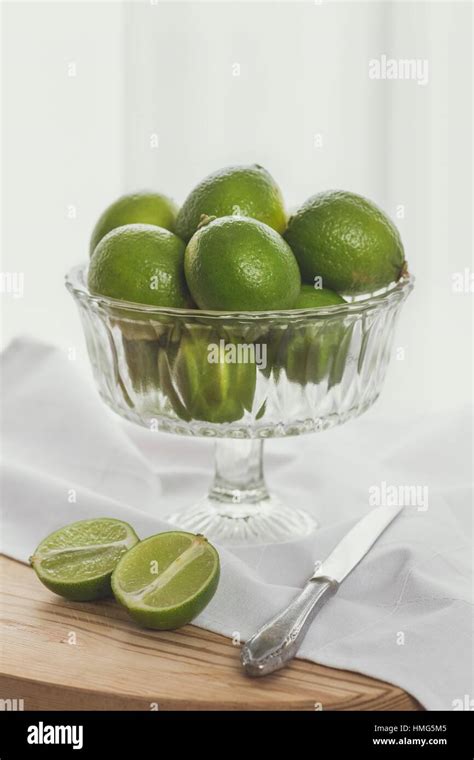 Old Fashioned Still Lfe Of Limes In A Glass Fruit Bowl And A Knife