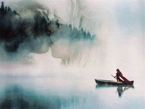 A Woman Sitting In A Boat On Top Of A Body Of Water Next To A Forest