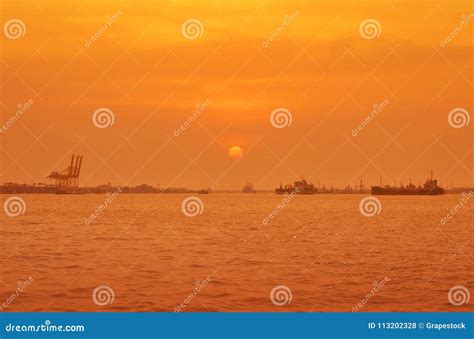 Cargo Ship with Port Over Sunset Sea Stock Photo - Image of cargo ...