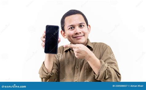 Smiling Face Expression Of Young Asian Malay Man Holding A Smartphone