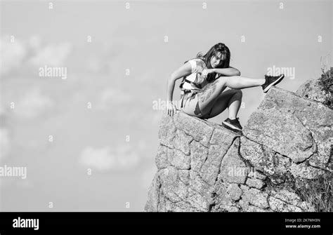 On Edge Of World Woman Sit On Edge Of Cliff In High Mountains Blue Sky