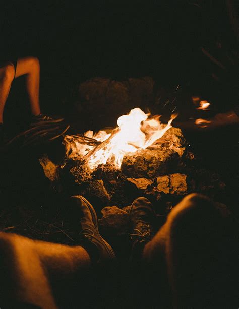 Group Of People Sitting Beside The Bonfire During Night Time Blaze