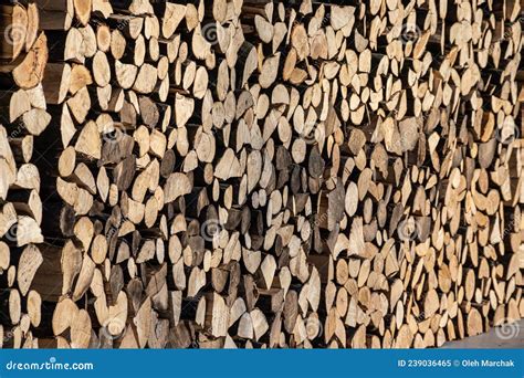 Pile Of Stacked Triangle Firewood Prepared For Fireplace And Boiler