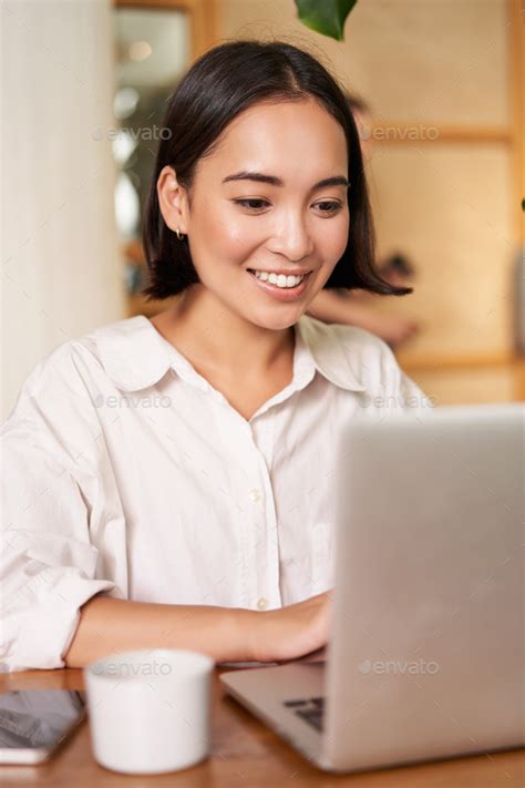 Stylish Brunette Woman With Laptop Sitting In Cafe And Drinking Coffee Smiling Happily Stock