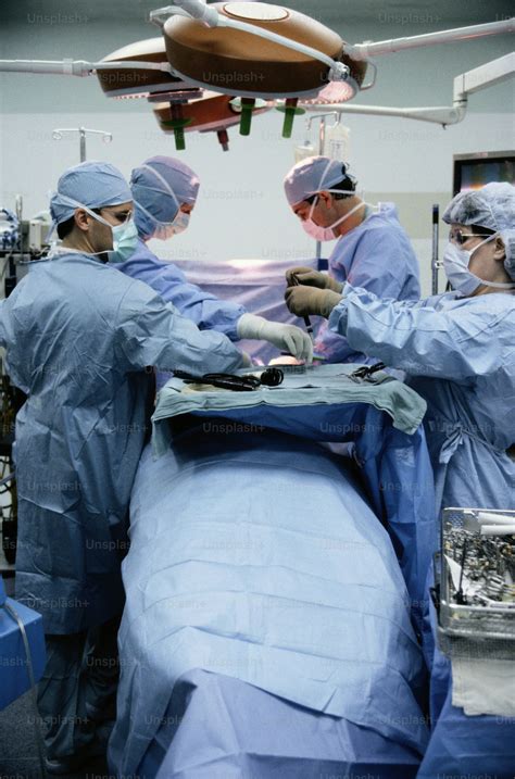 group  doctors performing surgery   hospital photo people