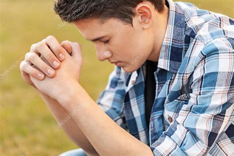 Handsome Young man praying — Stock Photo © billiondigital #114720352