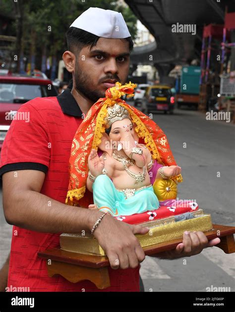 A Devotee Carries An Idol Of Elephant Headed Hindu God Ganesh To His