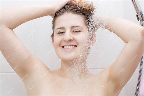 Premium Photo Cheerful Woman Standing At Shower And Washing Head